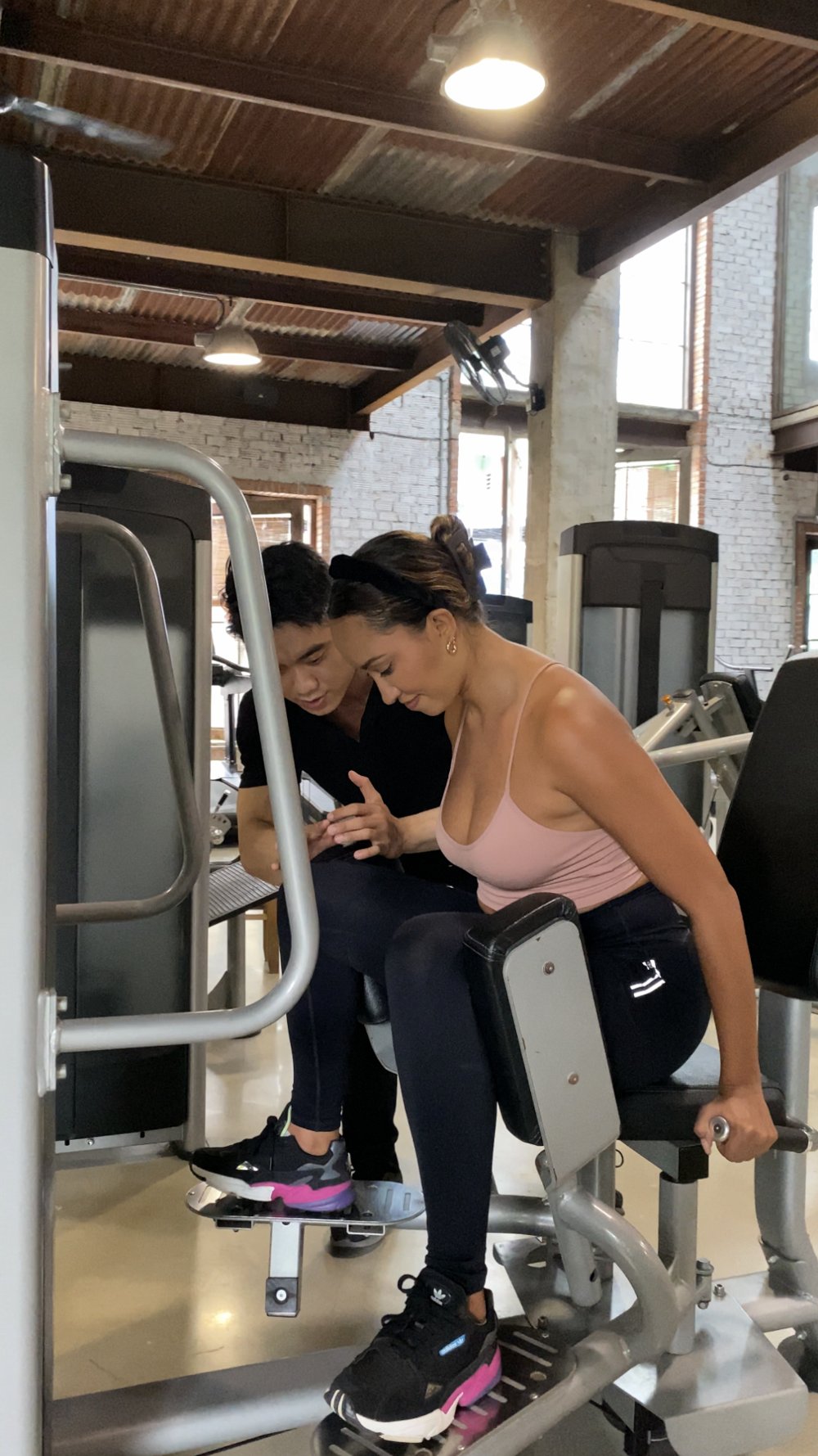 Jeff coaching a client through a leg machine exercise