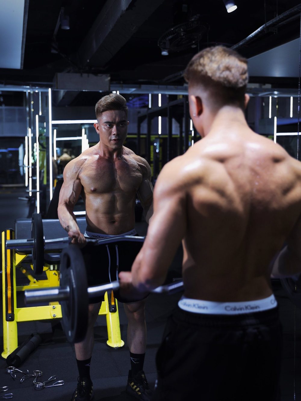 Jeff checking his form in the mirror with an EZ bar
